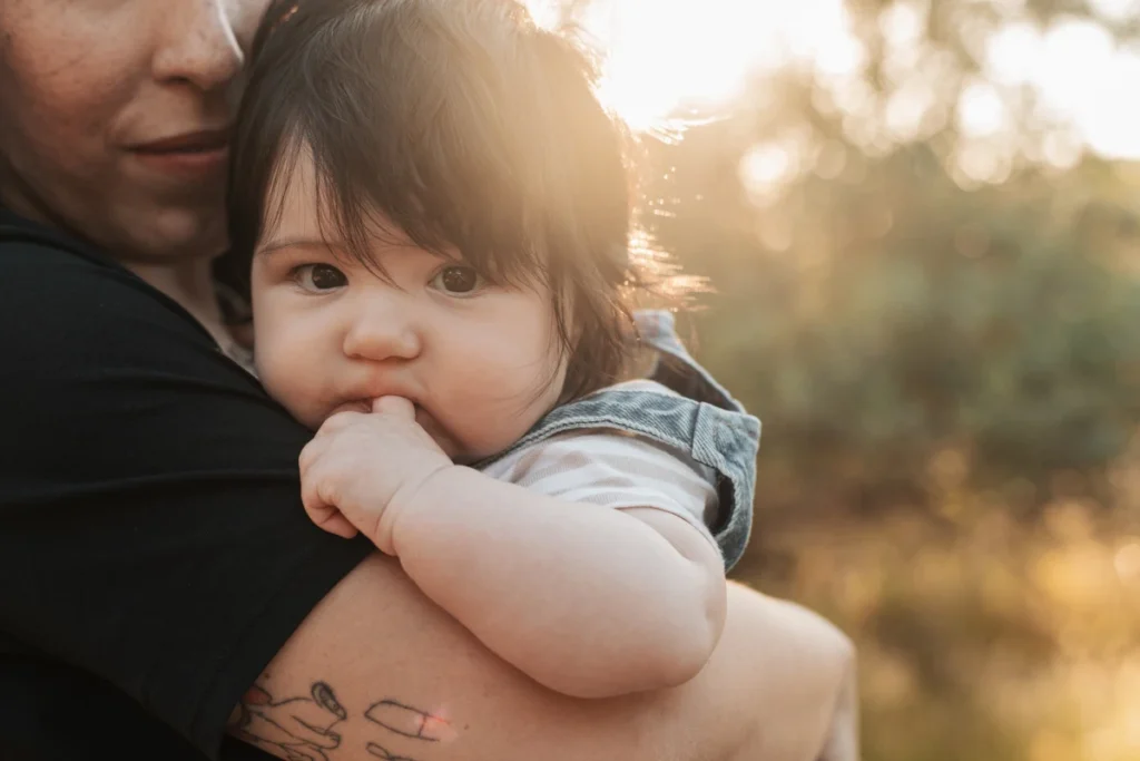 Sesión de fotos familiar y de bebés en exteriores en Barcelona. Madre e hijo posando al atardecer en la naturaleza.